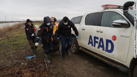 Turkish officials carry the bodies of people found frozen to death in Ipsala, close to the Greek border, on February 2. 