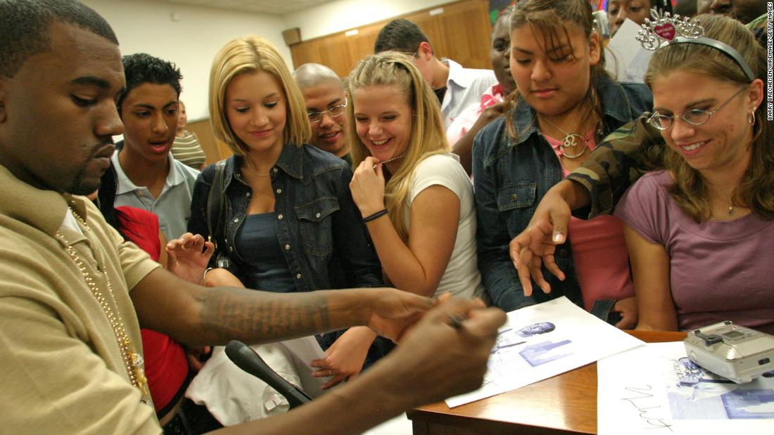 West signs autographs for a group of students in 2004.