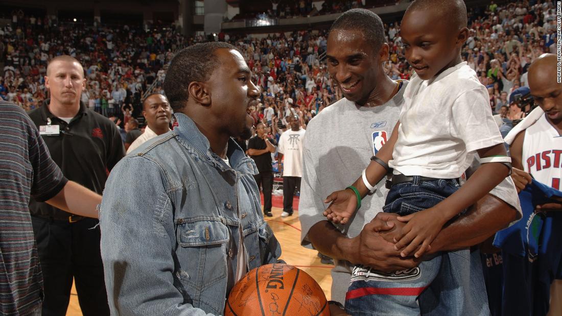 Basketball star Kobe Bryant talks with West on the court following a charity game in 2005.