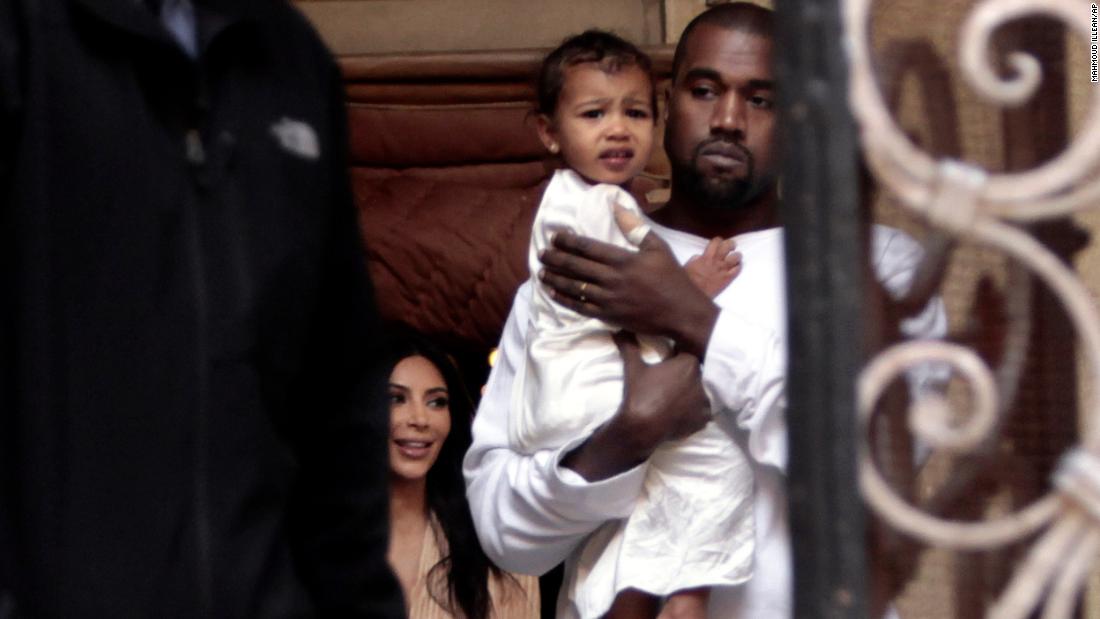 West holds his daughter, North, as he and his wife, Kim, visit a cathedral in Jerusalem in 2015.