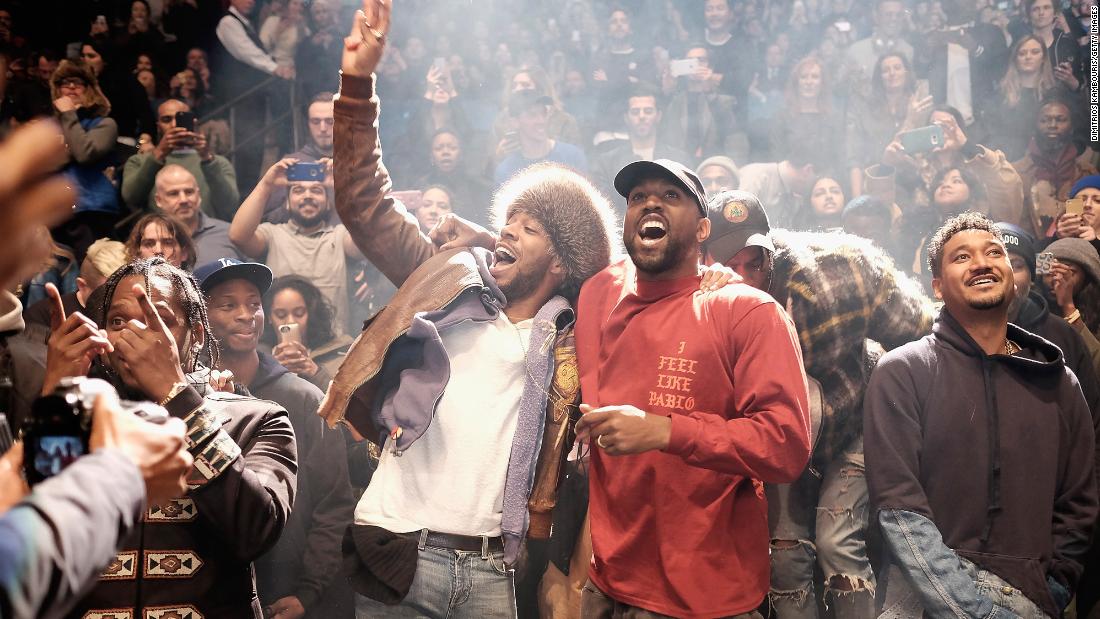 West performs at a Yeezy fashion show in 2016 along with Kid Cudi.