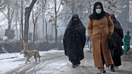 FILE PHOTO: Afghan women walk on the street during a snowfall in Kabul, Afghanistan, January 3, 2022. REUTERS/Ali Khara