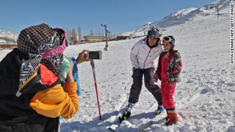 Iranian Olympic skier Atefeh Ahmadi poses with a young fan on the slopes of Abali, outside the capital  Tehran. The 21-year-old is the only woman from Iran to qualify for the Beijing Games, where she will be competing in the alpine skiing event.  