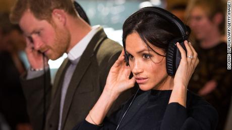 Prince Harry and his then-fiancée, Meghan Markle, listen to a broadcast through headphones during a visit to a community radio station in Brixton, southwest London on January 9, 2018.