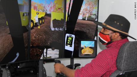 Using simulation equipment, a prospective student at Blue Ridge Community College in Virginia tries loading rocks using a backhoe. 