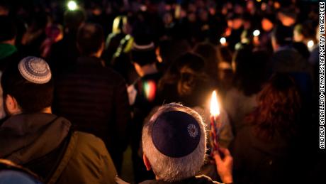 Members and supporters of the Jewish community come together for a candlelight vigil in remembrance of those who died during a shooting at the Tree of Life Synagogue in Pittsburgh.