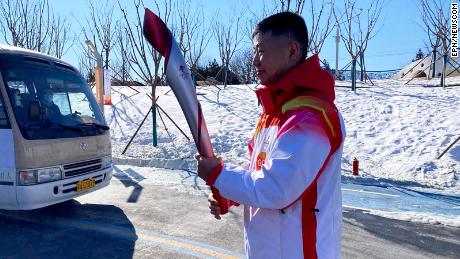 Qi Fabao, a regimental commander in the People&#39;s Liberation Army, carrying the Olympic torch on Wednesday Feb 2, 2022 at Olympic Forest Park, Beijing, China.