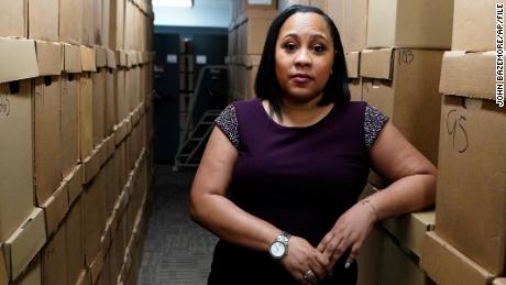 FILE - Fulton County District Attorney Fani Willis poses among boxes containing thousands of primal cases at her office, Wednesday, Feb. 24, 2021, file photo in Atlanta. Willis, weighing whether Donald Trump and others committed crimes by trying to pressure Georgia election officials to overturn Joe Biden&#39;s presidential victory said a decision on whether to bring charges could come as early as the first half of this year. (AP Photo/John Bazemore, File)