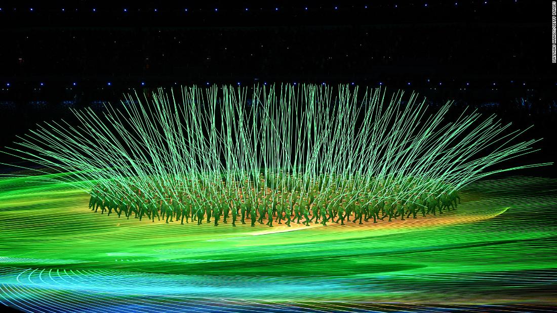 Performers create a flower display with LED lights during the opening ceremony.