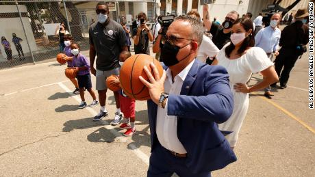 Education Secretary Miguel Cardona on the basketball court with mentors and students as he visits Fairfax High Schools Field Day event on July 14, 2021, in Los Angeles.