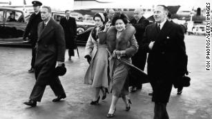 King George VI, left, is joined by his wife, Elizabeth, and Princess Margaret as he leaves an airport in London on January 31, 1952. They had waved farewell to Princess Elizabeth and her husband, Prince Philip, who were heading on a royal tour.