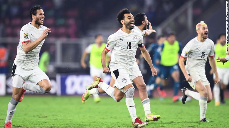 Mohamed Salah celebrates with teammates after winning the penalty shootout. 