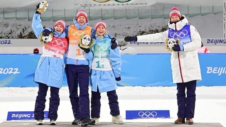 Norway&#39;s team of Olsbu Roeiseland, Johannes Thingnes Boe, Tiril Eckhoff and Tarjei Boe celebrate their first place on the podium.