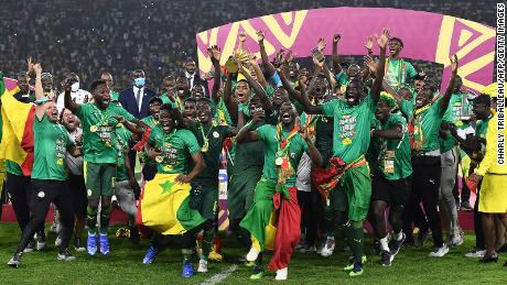 Senegal&#39;s players celebrate with the trophy after winning the Africa Cup of Nations match against Egypt on February 6, 2022.