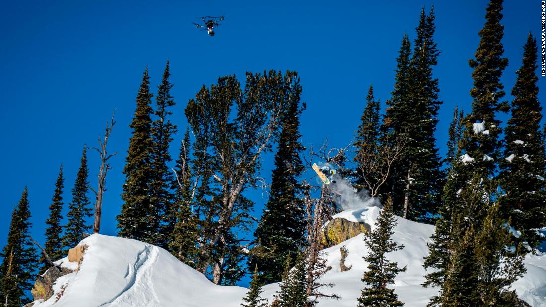 Built by professional drone racer and aerial cinematographer Gabriel Kocher, the drones have eight motors, a customized rotating gimbal, full broadcast system and stabilization platform, and can travel at up to 100 miles per hour. Pictured, Danny Davis and a drone in Jackson Hole.