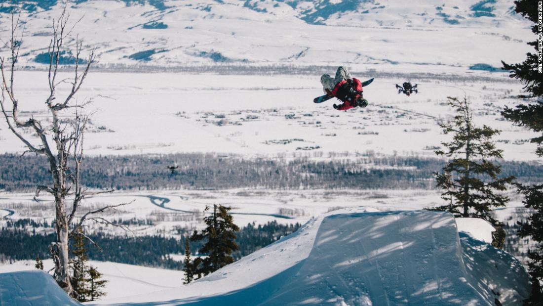 Kocher says that he has to tap into his seven years&#39; experience as a professional drone racer in order to keep up with the riders -- simultaneously predicting their routes, engineering the best possible filming angles, and avoiding the trees dotted across the mountainside. Pictured, Sage Kotsenburg and a drone in Jackson Hole.