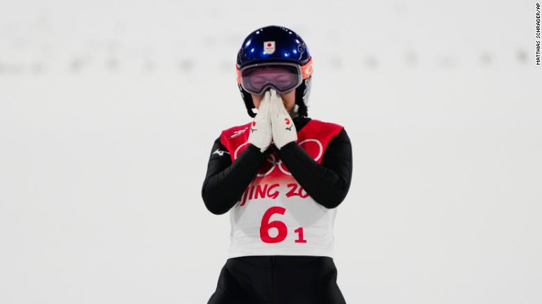 Takanashi reacts after her jump during the ski jumping mixed team final at the 2022 Winter Olympics.