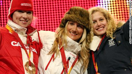 Silver medal winner Jacobellis (right), gold medal winner Tanja Frieden (middle) and bronze medal winner Dominique Maltais (left) celebrate on the pdium after the women&#39;s snowboard cross on February 17, 2006 in Turin, Italy.