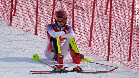 Mikaela Shiffrin sits on the side of the course after skiing out in the first run of the women&#39;s slalom.