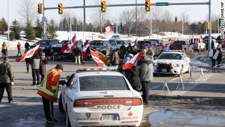 People take part in a protest blocking traffic at the Ambassador Bridge, linking Windsor, Ontario, and Detroit on Wednesday, February 9.