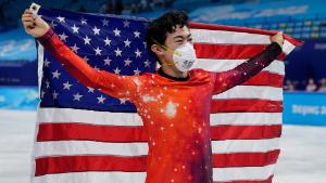 Nathan Chen, of the United States, holds his national flag as he celebrates after winning the gold medal in the men&#39;s free skate program during the figure skating event at the 2022 Winter Olympics, Thursday, Feb. 10, 2022, in Beijing. (AP Photo/David J. Phillip)