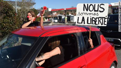 A placard that reads, &quot;We are liberty&quot; is held out of a car window as one convoy leaves Bayonne on February 9.