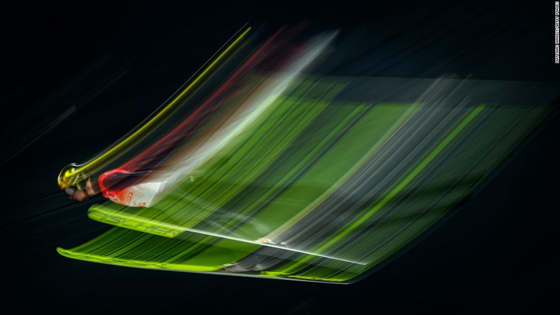 In this photo taken with a slow shutter speed, German ski jumper Karl Geiger competes in the large hill event on February 11. He ended up winning the bronze.