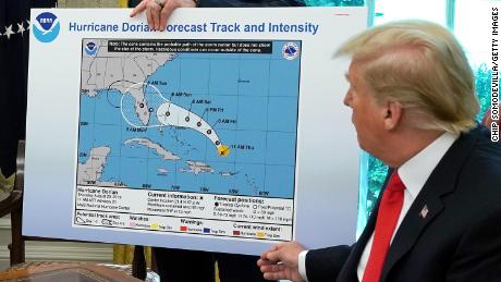 President Donald Trump references a map during a briefing from officials about Hurricane Dorian in the the White House in September 2019. The National Archives said the map was not transfered to them at the end of Trump&#39;s presidency.