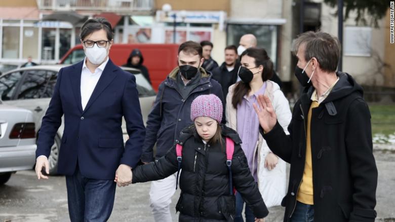 President Stevo Pendarovski held Embla Ademi&#39;s hand as he walked her to her school in the city of Gostivar on Monday. 