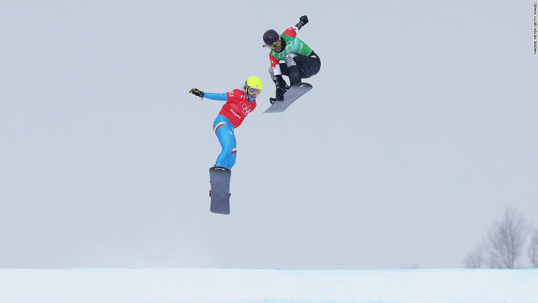 The United States&#39; Lindsey Jacobellis grabs her board as she edges Italy&#39;s Michela Moioli &lt;a href=&quot;https://www.cnn.com/world/live-news/beijing-winter-olympics-02-12-22-spt/h_c84b265d05bc843152d2171dcd9a92bb&quot; target=&quot;_blank&quot;&gt;to win the mixed team snowboard cross event&lt;/a&gt; on February 12. It was reminiscent of the 2006 Olympics, when Jacobellis went for a showoff move on the last jump and then fell, finishing second in the women&#39;s event. It was her second gold in Beijing.