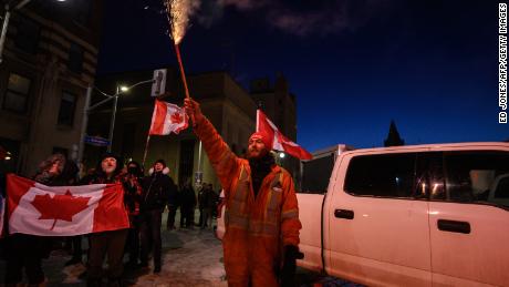 A demonstrator lets off fireworks during a protest by truck drivers over pandemic health rules and the Trudeau government, outside the parliament of Canada in Ottawa on February 12.