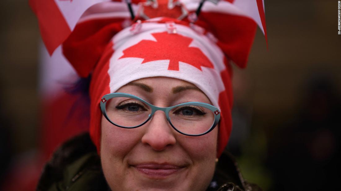 A protester wears Canadian flags on her head during a protest outside Parliament on February 11.