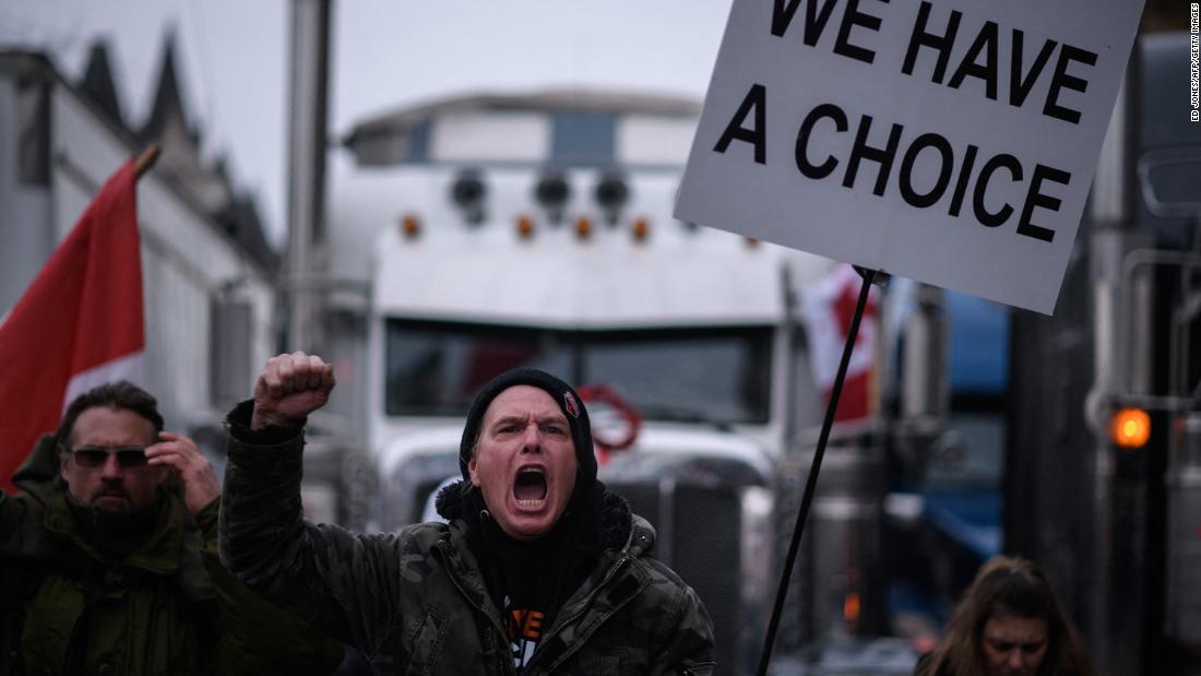 A demonstrator shouts during a protest outside Parliament on Friday, February 11. Canada&#39;s Ontario province declared a state of emergency Friday over the trucker-led protests paralyzing the capital and blocking trade with the United States.