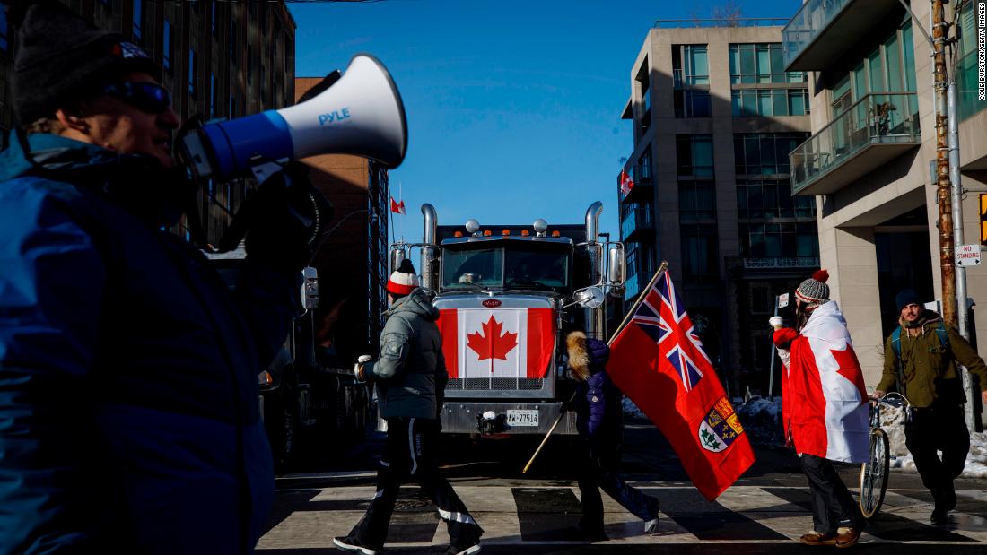 Supporters of the protesters pass by a honking truck near Queen&#39;s Park in Toronto on February 5.