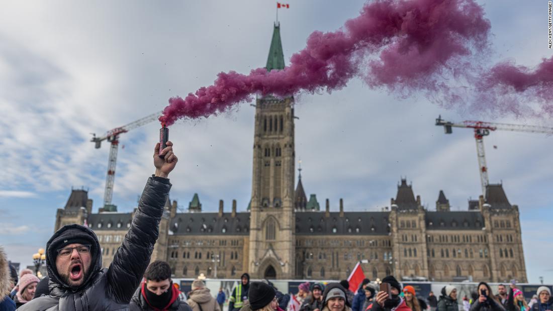 A man holds a firework during a protest in Ottawa on January 29.