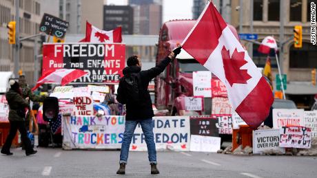 A protesters waves a flag Friday in Ottawa.