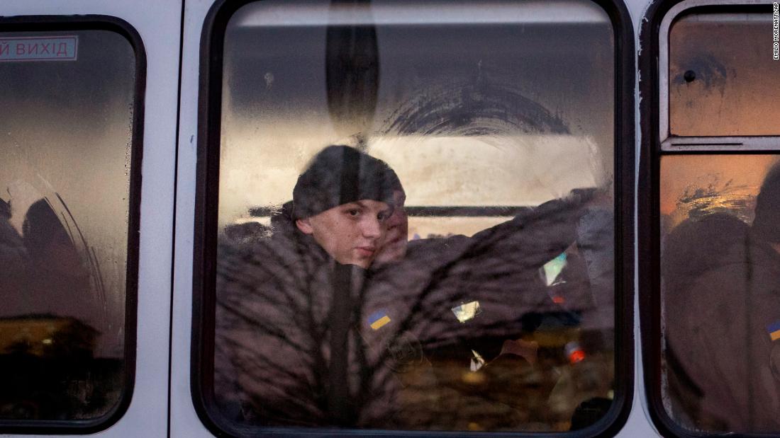 Members of Ukraine&#39;s National Guard look out a window as they ride a bus through the capital of Kyiv on February 14.