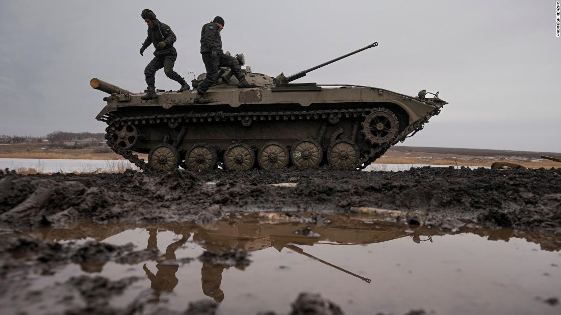 Ukrainian service members walk on an armored fighting vehicle during a training exercise in eastern Ukraine's Donetsk region on February 10.