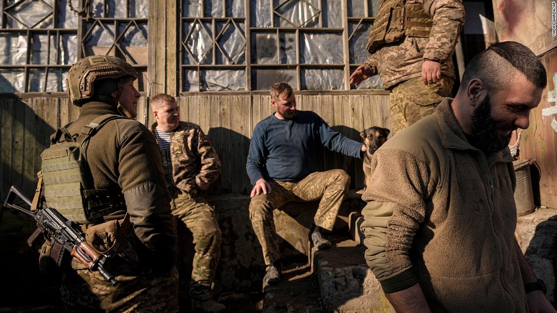 Ukrainian service members talk at a front-line position in eastern Ukraine on Monday, February 14. 