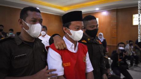 Indonesian teacher Herry Wirawan (center) at a court in Bandung, West Java on February 15, 2022.