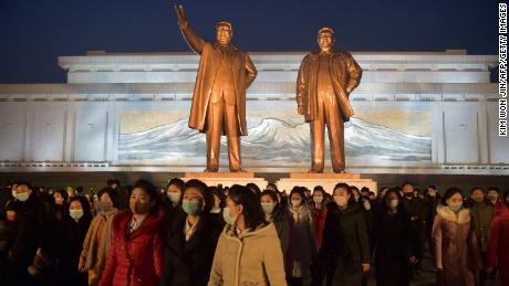 People gather before the statues of late North Korean leaders Kim Il Sung and Kim Jong Il in 2021 to mark the 10th anniversary of Kim Jong Il&#39;s death.