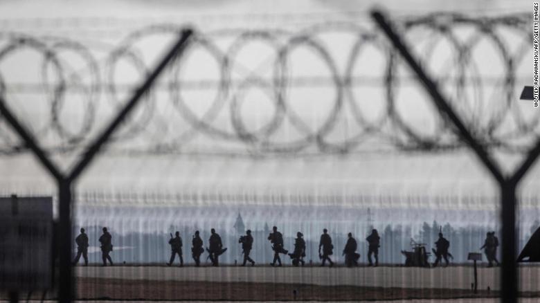 US troops walk on the tarmac at the Rzeszów-Jasionka Airport in southeastern Poland on February 16. US paratroopers landed in Poland as part of a deployment of several thousand sent to bolster NATO's eastern flank in response to tensions with Russia.