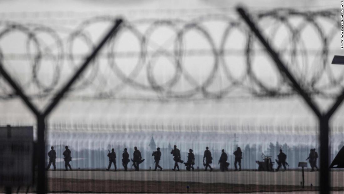 US Army troops walk on the tarmac at the Rzeszów-Jasionka Airport in southeastern Poland on Wednesday, February 16. US paratroopers landed in Poland as part of a deployment of several thousand sent to bolster NATO&#39;s eastern flank in response to tensions with Russia.