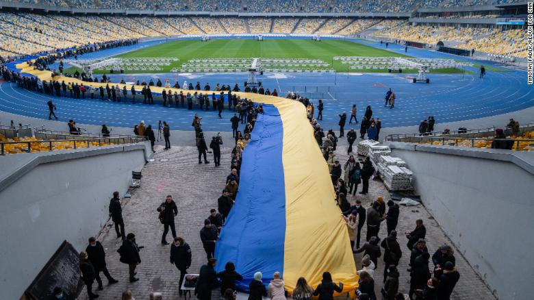 A 200-meter-long Ukrainian flag is unfolded at the Olympic Stadium in Kyiv on February 16 to mark a "Day of Unity," an impromptu celebration declared by President Volodymyr Zelensky.