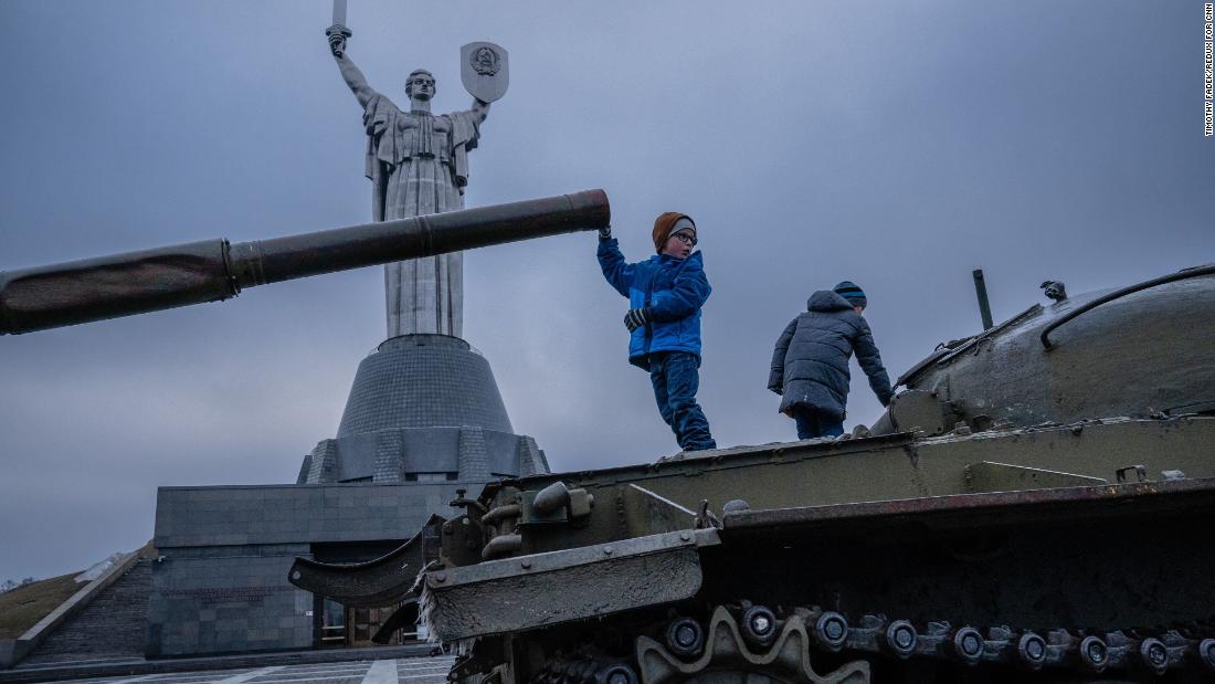 Children play on old Soviet tanks in front of the the Motherland Monument in Kyiv on February 16.