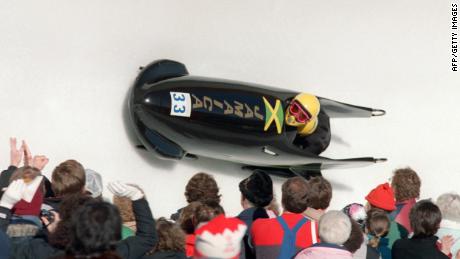 Jamaica&#39;s first-ever bobsledders, pilot Dudley &#39;Tal&#39; Stokes and brakeman Michael White, are cheered on by fans during the first run of the Olympic two-man bobsled event February 20, 1988 at the Canada Olympic Park in Calgary. Stokes and White placed 31st out of 41.