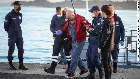 A rescued passenger arrives at the port of Corfu on Friday, after hundreds were evacuated from the ship.