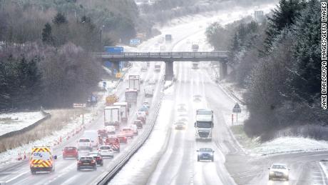 Motorists drive through the sleet and snow along the M8 motorway near Bathgate in West Lothian as Storm Eunice sweeps across the UK after hitting the south coast earlier on Friday.