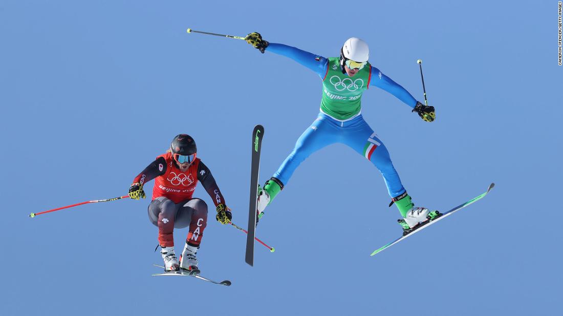 Canada&#39;s Brady Leman, left, and Italy&#39;s Simone Deromedis fly through the air during a ski cross race on February 18.