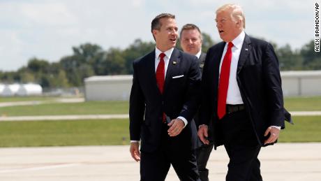 Then-Gov. Eric Greitens, at left, walks with then-President Donald Trump as they arrive in Springfield, Missouri in August 2017. 